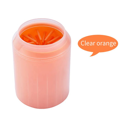 Clear orange silicone paw rinse cup on a white background