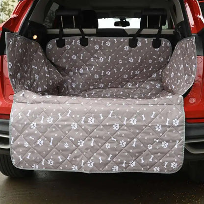 Grey quilted Tuckbury cargo liner fitted in the open boot of a red SUV