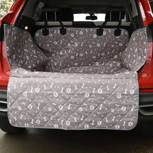 Grey quilted Tuckbury cargo liner fitted in the open boot of a red SUV